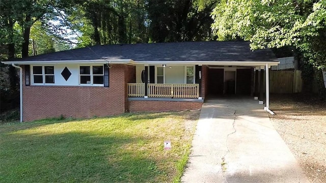 single story home featuring driveway, a porch, a front yard, a carport, and brick siding