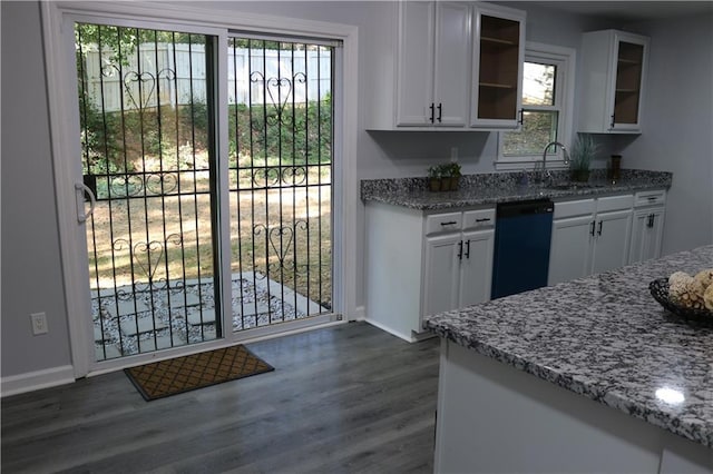 kitchen with light stone countertops, dishwasher, white cabinets, and dark wood finished floors