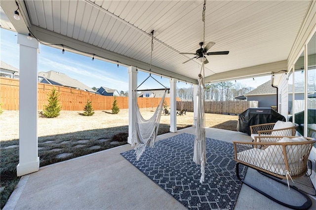 view of patio / terrace with a ceiling fan, a fenced backyard, and a grill