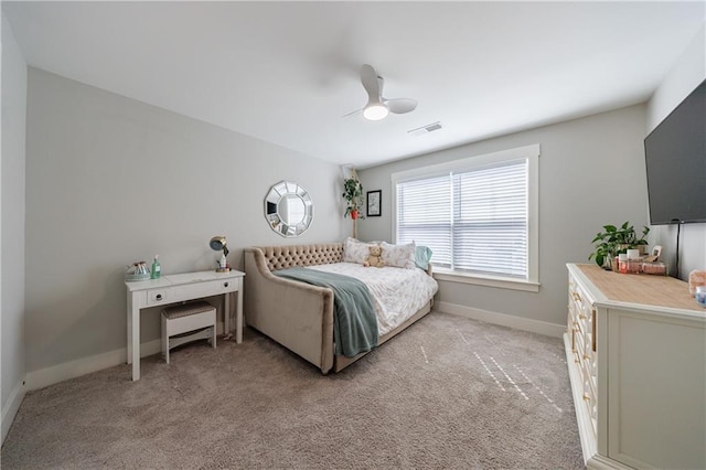 bedroom featuring baseboards, visible vents, a ceiling fan, and light colored carpet