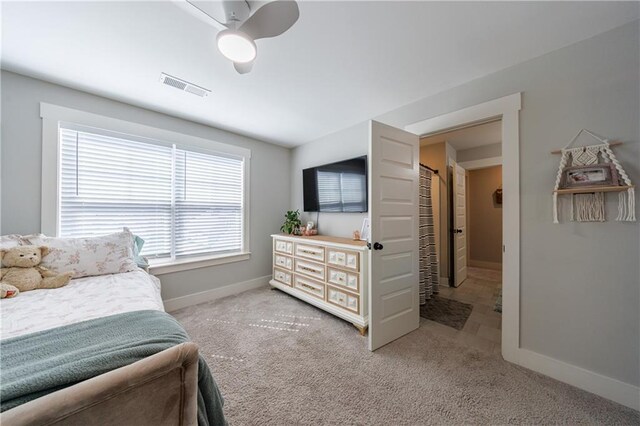 bedroom featuring a ceiling fan, carpet flooring, visible vents, and baseboards