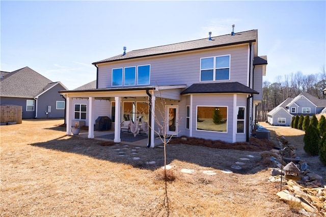 back of house with a patio