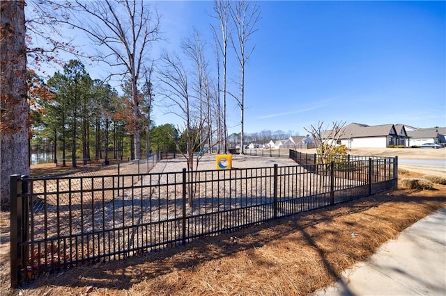 view of gate featuring a residential view and fence