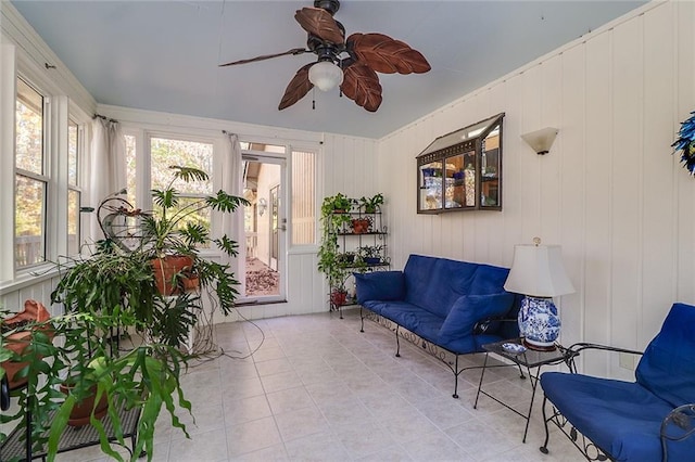 sunroom / solarium featuring ceiling fan