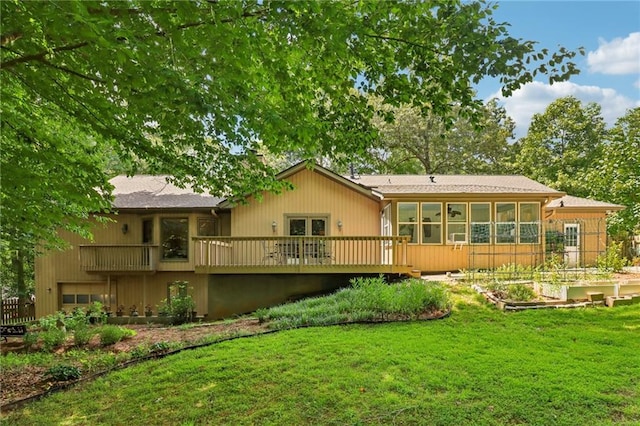 back of house with a sunroom, a yard, and a wooden deck