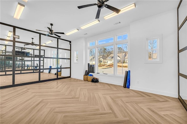 spare room featuring ceiling fan and light parquet floors