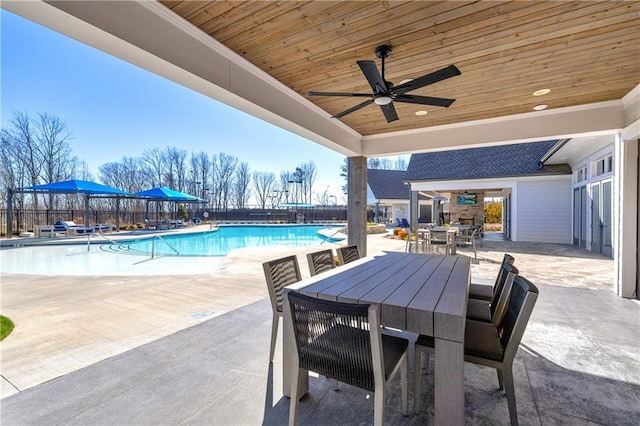 view of swimming pool with ceiling fan and a patio