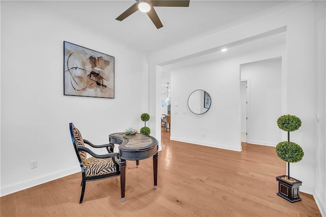 sitting room featuring light hardwood / wood-style floors and ceiling fan