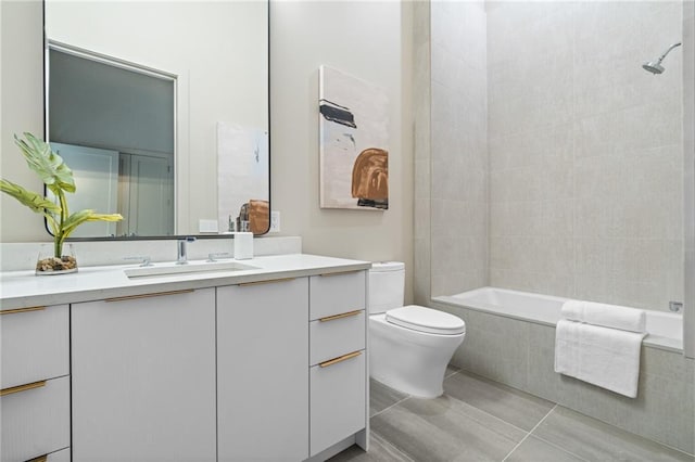 full bathroom with toilet, tiled shower / bath, tile patterned floors, and vanity