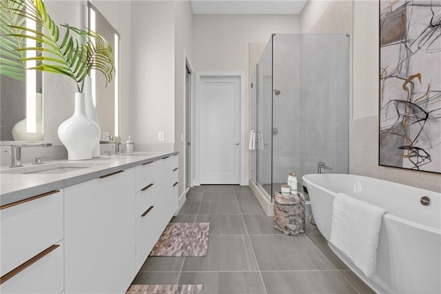 bathroom featuring tile patterned flooring, separate shower and tub, and vanity