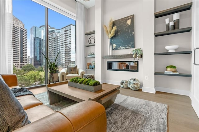 sitting room with built in features and light wood-type flooring