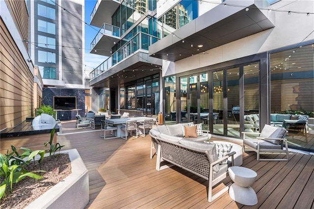 wooden deck with an outdoor living space