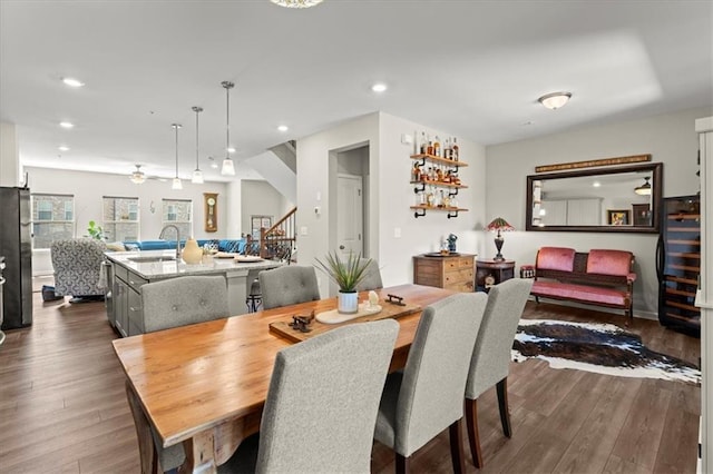 dining room with sink and dark hardwood / wood-style flooring