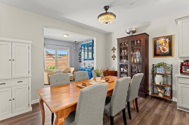 dining area featuring dark hardwood / wood-style flooring