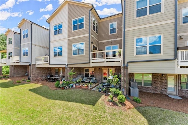 rear view of property featuring a yard