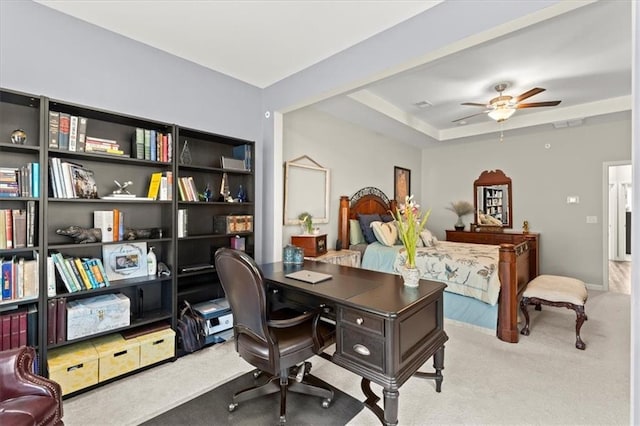 home office featuring light carpet and ceiling fan