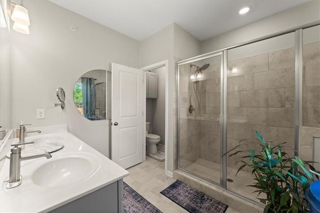 bathroom with toilet, an enclosed shower, vanity, and tile patterned flooring