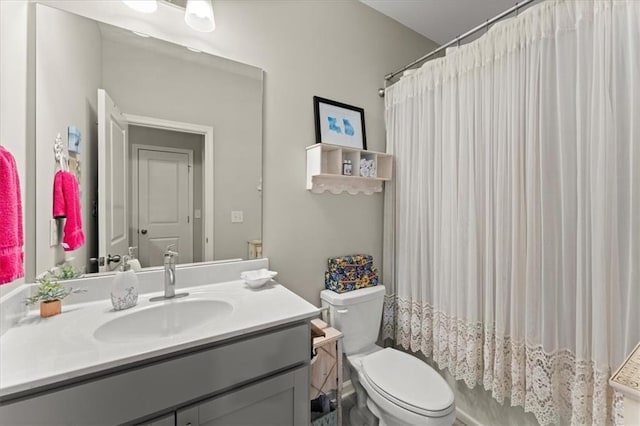 full bathroom featuring toilet, shower / bath combination with curtain, and vanity