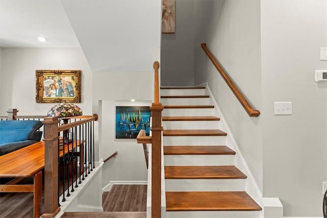 stairway with hardwood / wood-style floors