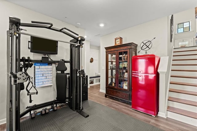 workout area featuring dark wood-type flooring