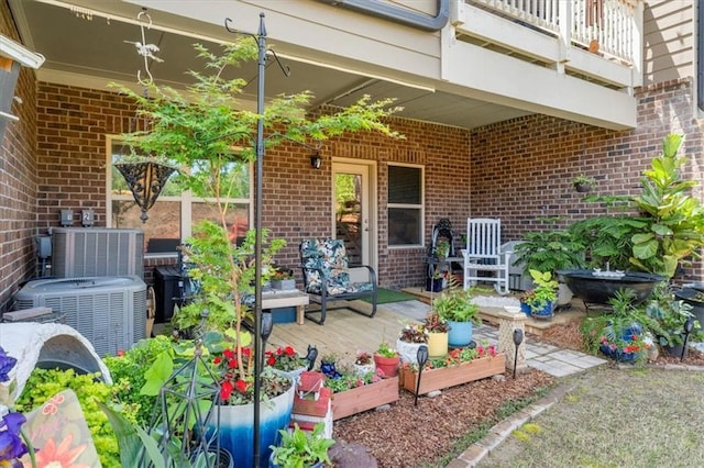 view of patio / terrace featuring a balcony, a deck, and central AC unit