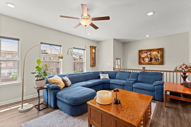 living room featuring ceiling fan, a wealth of natural light, and hardwood / wood-style flooring