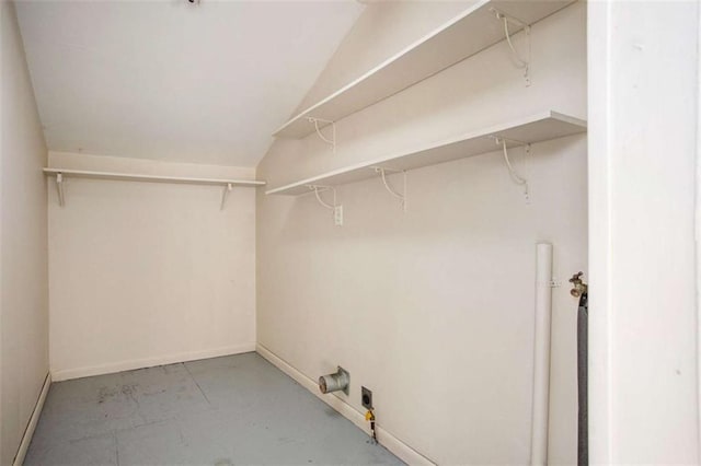 walk in closet with lofted ceiling