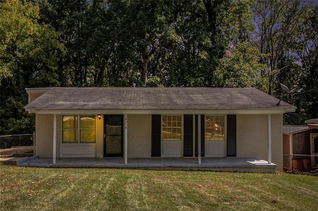 back of property featuring a lawn