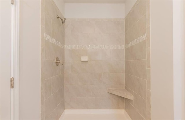 bathroom with a tile shower