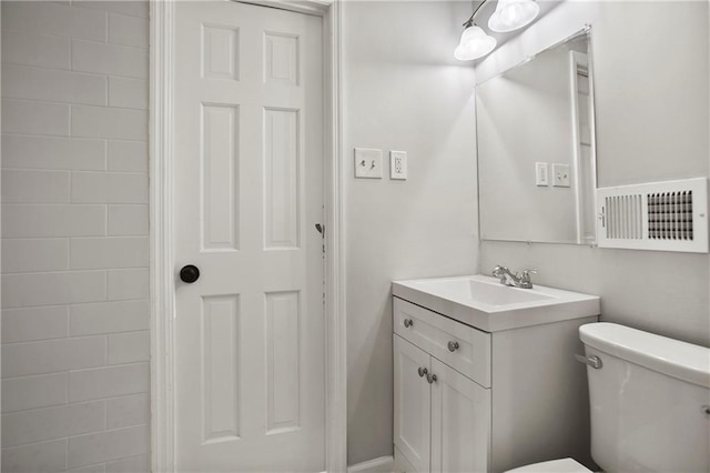 bathroom with toilet and vanity