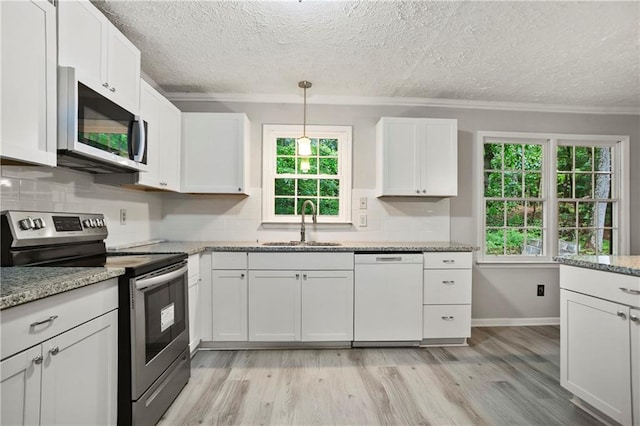 kitchen featuring white dishwasher, stainless steel range with electric stovetop, crown molding, a sink, and a textured ceiling