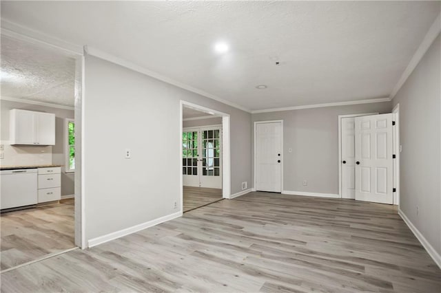 foyer with light wood-style flooring, crown molding, baseboards, and a textured ceiling
