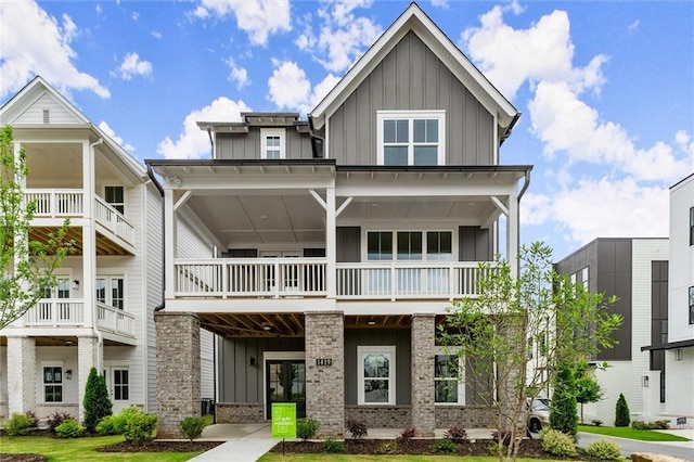 1419 Coretta Bnd, Atlanta, GA 30318 - view of front facade featuring board and batten siding, a balcony, and brick siding