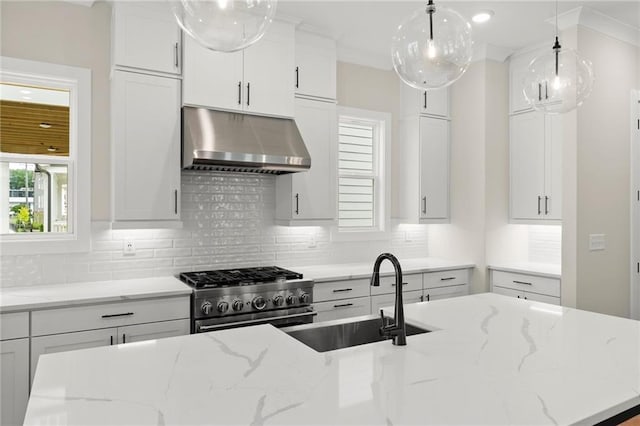 1419 Coretta Bnd, Atlanta, GA 30318 - kitchen with under cabinet range hood, stainless steel stove, a sink, and decorative backsplash