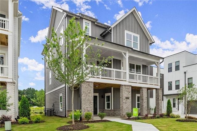 1419 Coretta Bnd, Atlanta, GA 30318 - view of front of home with board and batten siding, a front lawn, central AC unit, and a balcony
