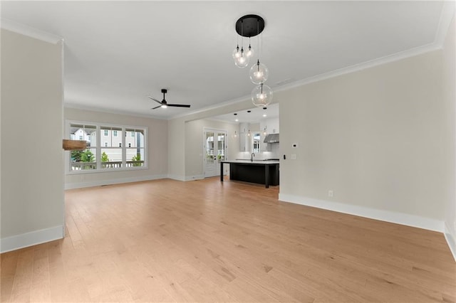 1419 Coretta Bnd, Atlanta, GA 30318 - unfurnished living room with ornamental molding, ceiling fan, light wood-style flooring, baseboards, and a sink