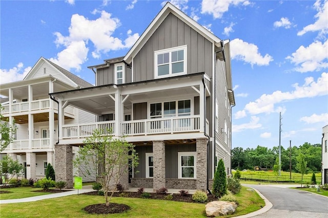 1419 Coretta Bnd, Atlanta, GA 30318 - view of front facade featuring board and batten siding, a balcony, and a front yard