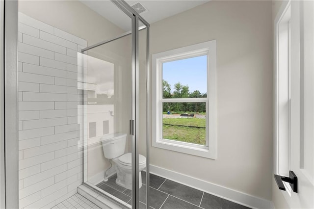 1419 Coretta Bnd, Atlanta, GA 30318 - full bathroom with tile patterned flooring, a stall shower, toilet, and baseboards