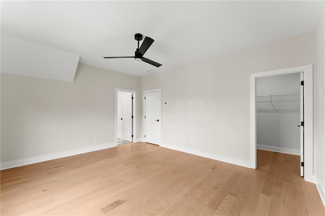 1419 Coretta Bnd, Atlanta, GA 30318 - unfurnished bedroom featuring light wood-style flooring, baseboards, a walk in closet, ceiling fan, and a closet
