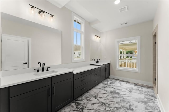 1419 Coretta Bnd, Atlanta, GA 30318 - bathroom featuring marble look tile flooring, double vanity, and baseboards