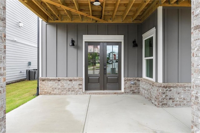 1419 Coretta Bnd, Atlanta, GA 30318 - entrance to property featuring board and batten siding, french doors, a patio, and brick siding