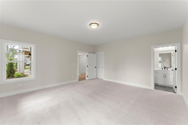 1419 Coretta Bnd, Atlanta, GA 30318 - unfurnished bedroom with light carpet, baseboards, and ensuite bath