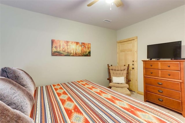 bedroom with light tile patterned floors, ceiling fan, and visible vents