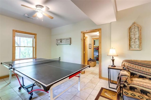 game room featuring light tile patterned floors, a ceiling fan, and baseboards