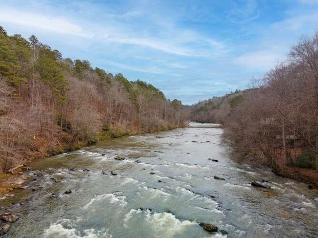 view of road featuring a water view and a wooded view