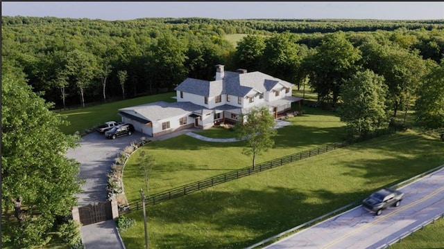bird's eye view with a wooded view