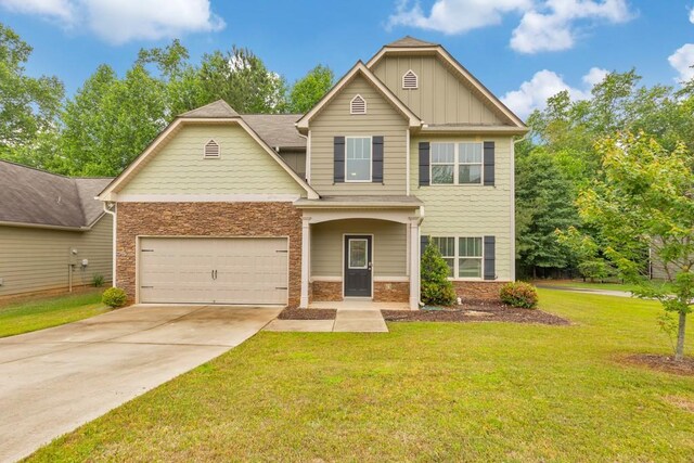 craftsman inspired home featuring driveway, a front yard, board and batten siding, stone siding, and a garage