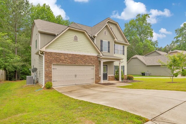 craftsman inspired home with stone siding, concrete driveway, cooling unit, and a front lawn