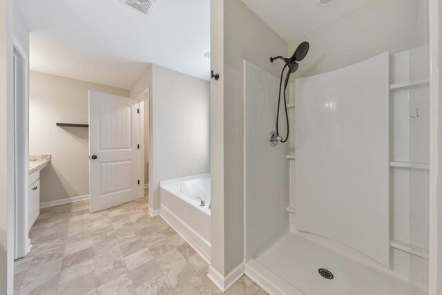 full bathroom featuring a shower, a bath, vanity, and baseboards