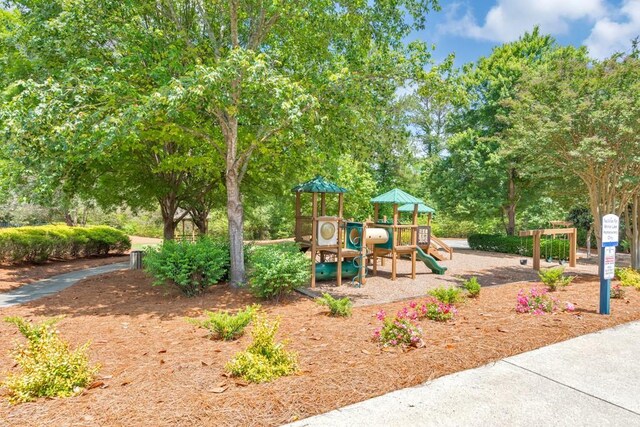 community play area featuring view of wooded area